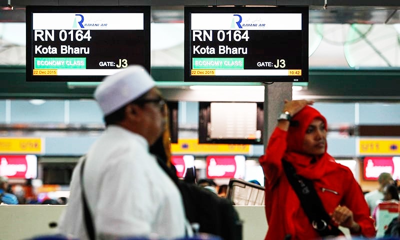 Muslim travellers queue up in front of Rayani Air's check-in counter at Kuala Lumpur International Airport 2 in Sepang, Malaysia. — AP