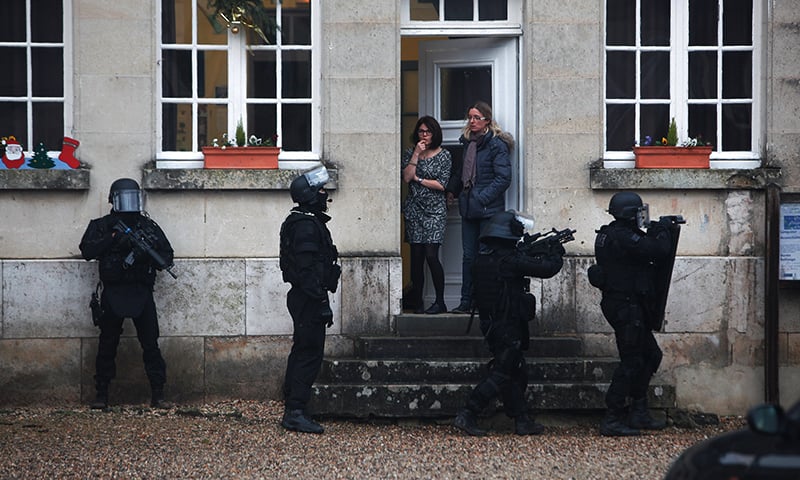 French riot officers patrol in Longpont, north of Paris, after an attack on the satirical newspaper Charlie Hebdo. — AP