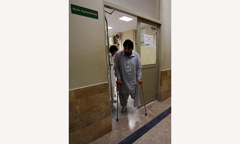 A victim of an improvised explosive device (IED) leaves the gym at the Pakistan Institute of Prosthetic and Orthotic Sciences (PIPOS) in Peshawar. — AFP