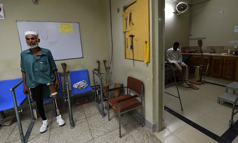 An improvised explosive device (IED) victims exercise with artificial limbs at the Pakistan Institute of Prosthetic and Orthotic Sciences (PIPOS) in Peshawar. — AFP