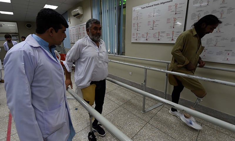 An improvised explosive device (IED) victims exercise with artificial limbs at the Pakistan Institute of Prosthetic and Orthotic Sciences (PIPOS) in Peshawar. — AFP