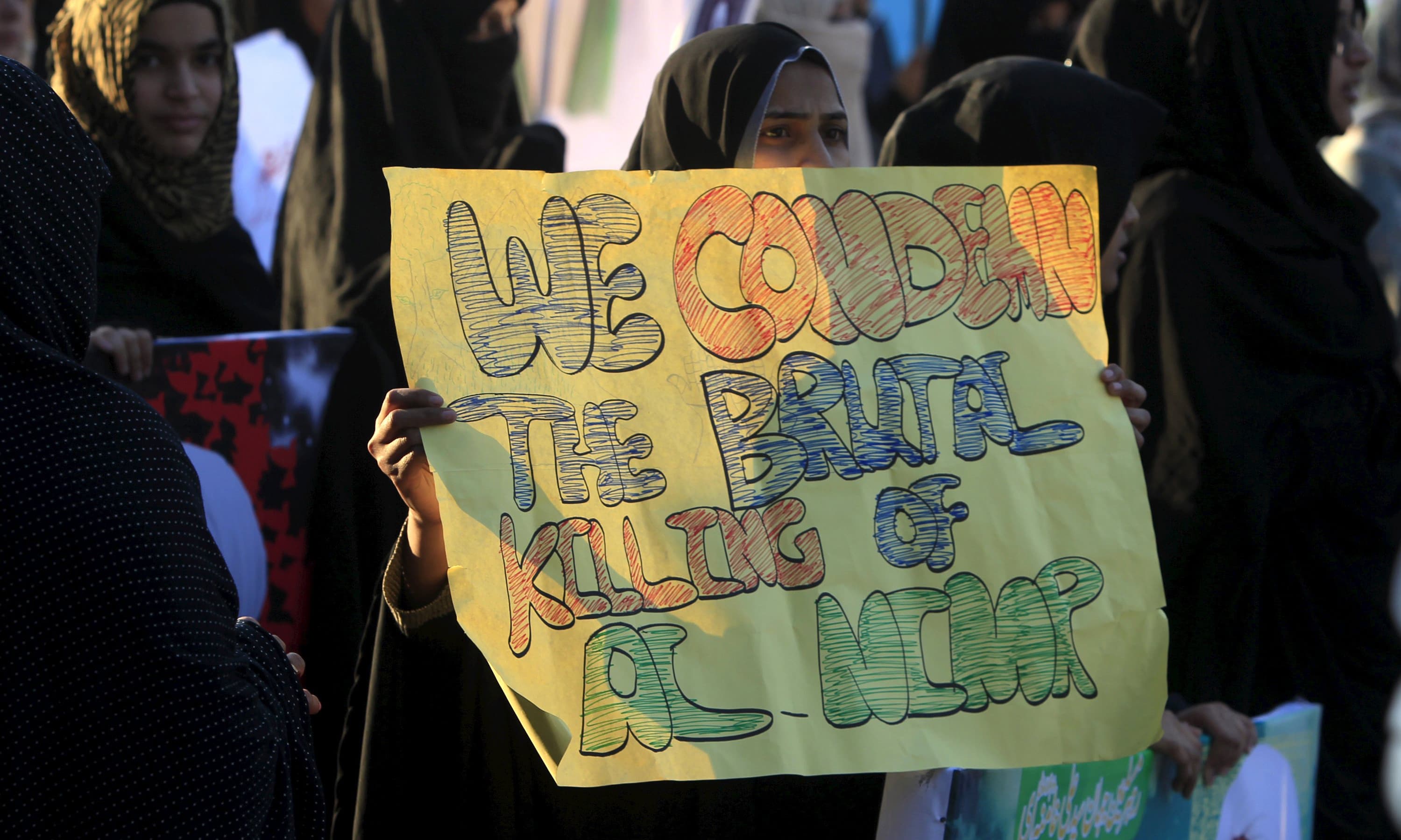 A woman holds a sign for cleric Nimr al-Nimr, who was executed along with others in Saudi Arabia. —Reuters