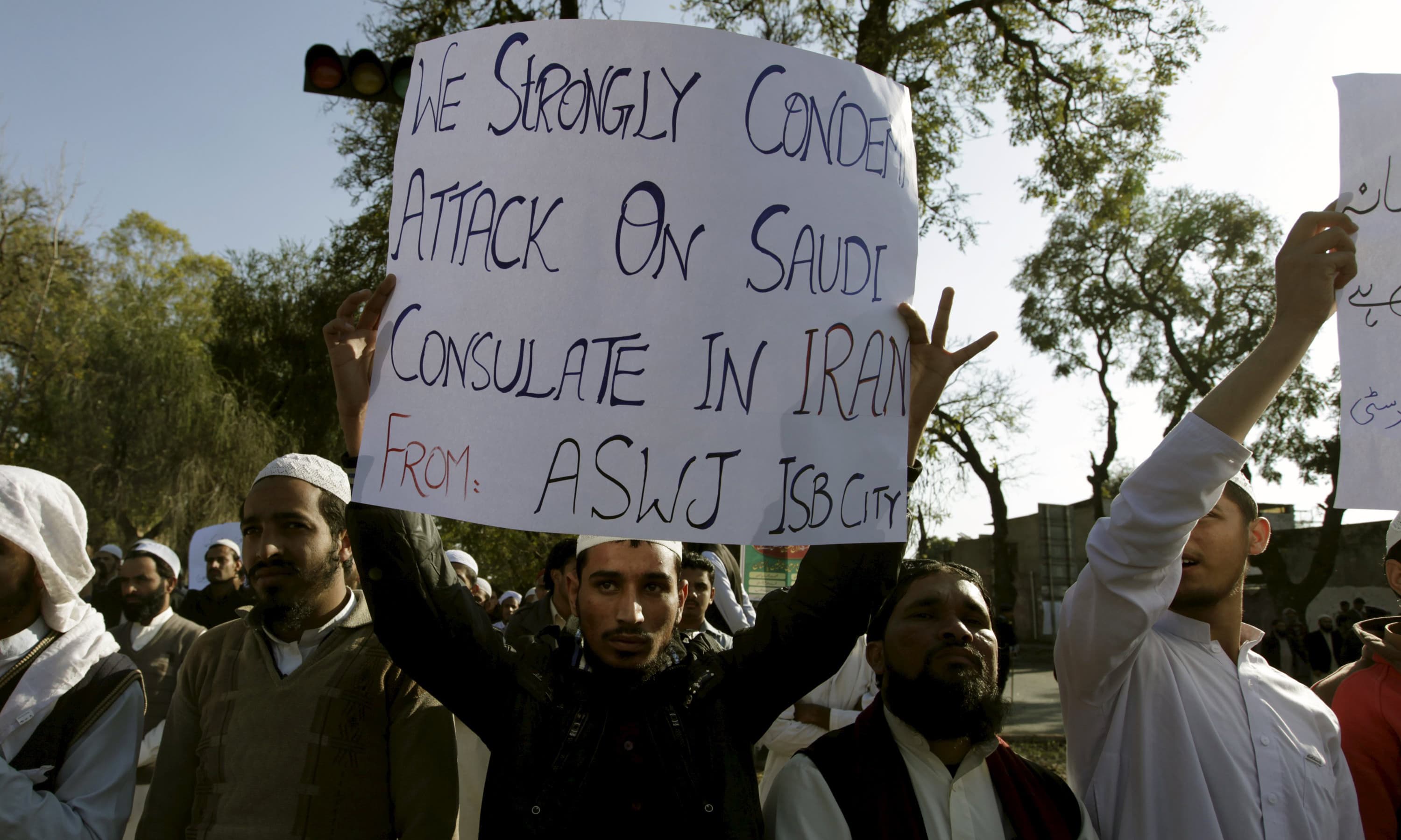 An ASWJ supporter  holds a placard to condemn the attack on Saudi consulate in Iran. —Reuters