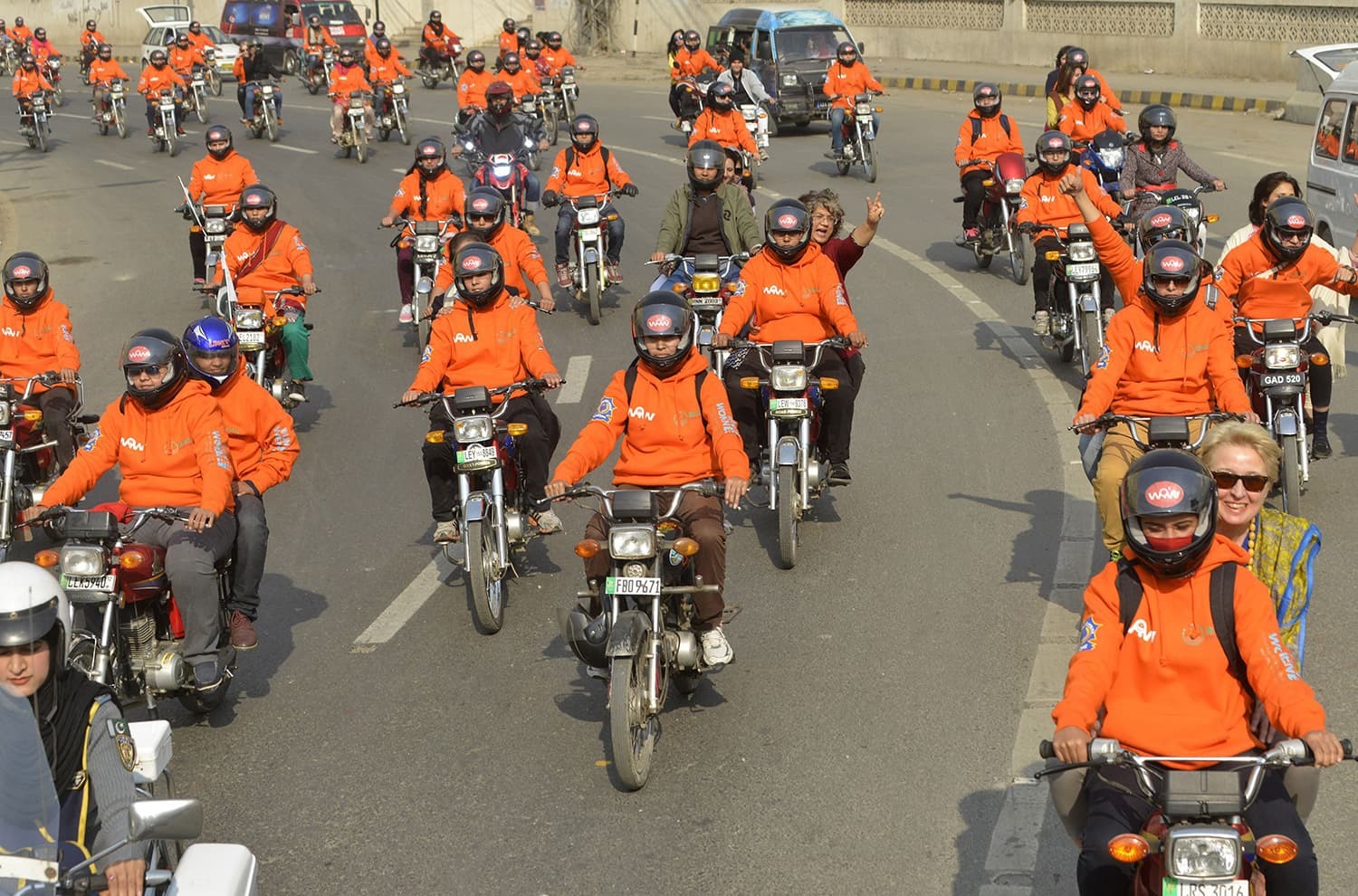 Women participants of Women on Wheels (WOW) ride their motor-bikes during a rally launching the Women on Wheels campaign in Lahore.─AFP