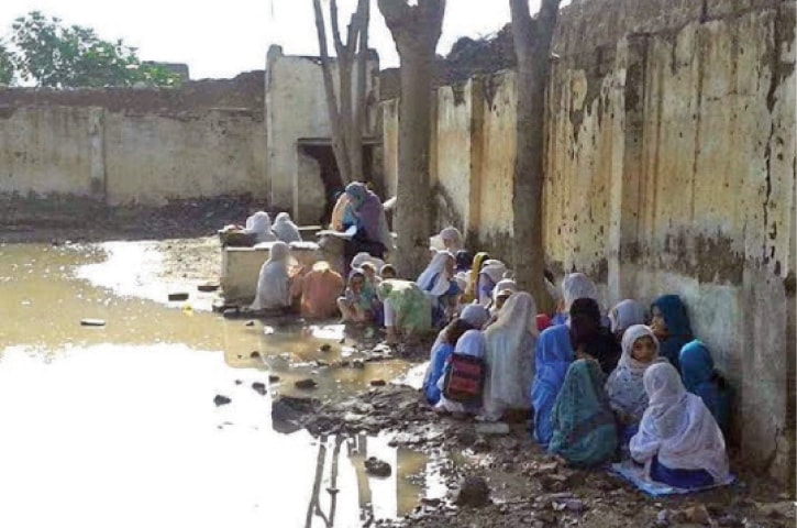 Students attend a class in dismal condition at a government primary school in Landi Kotal, Khyber Agency. &mdash; Dawn