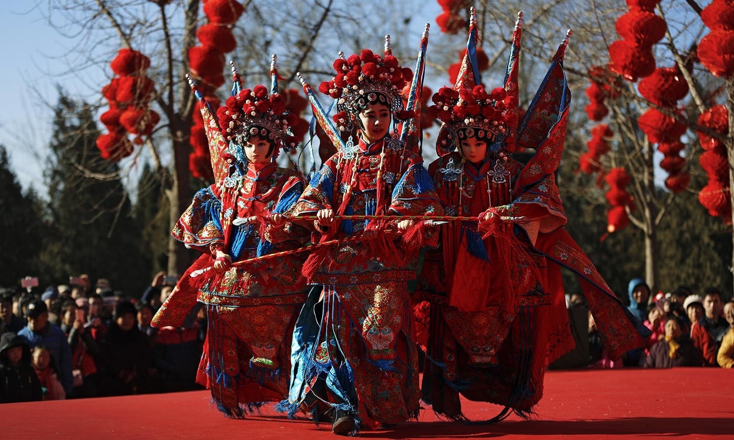 A Chinese dancer dressed in traditional costume performs a cultural dance on stage during a temple fair. ─ AP