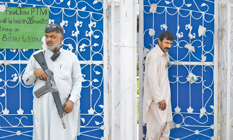 A security personnel stands outside the ICMS School in Peshawar