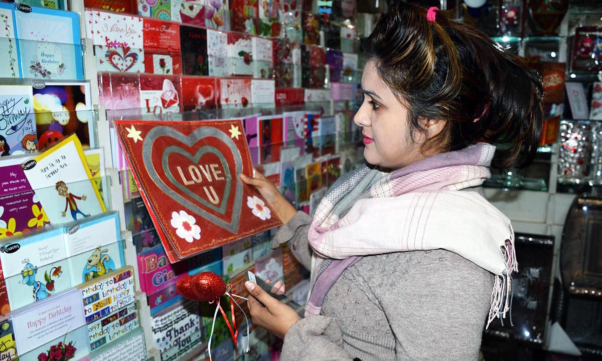 Woman seen buying card at a shop in Multan.—Online