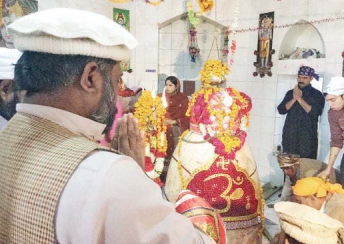Hindu devotees perform rituals at the historic Shiv temple in Chatti Gatti area of Mansehra. &mdash; Dawn