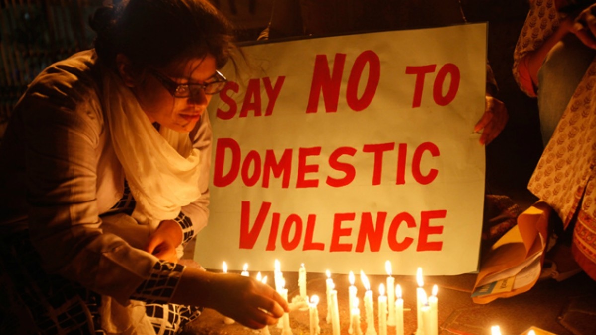 Women light candles for International Women's Day at a rally in Karachi