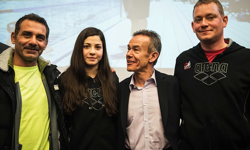 Syrian swimmer Yusra Mardini (2ndL), her father Izzat (L), coach Sven Spannekrebs (2ndR) and Pere Miro of the International Olympic Committee (IOC) pose for a picture after a press conference in Berlin on March 18, 2016.—AFP