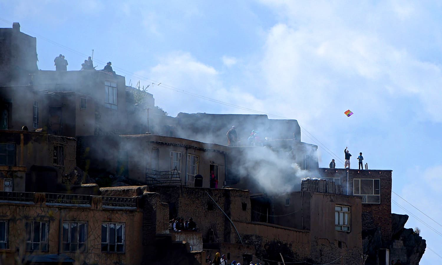 Afghan youths fly kites as devotees gather to watch proceedings at The Sakhi Shrine in Kabul. ─ AFP