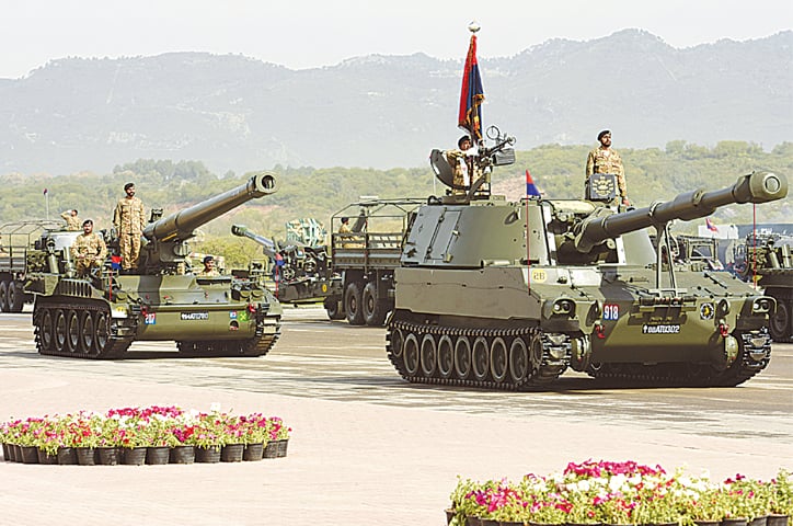 ISLAMABAD: Soldiers stand alert on battle tanks taking part in the Pakistan Day parade here on Wednesday.&mdash;White Star