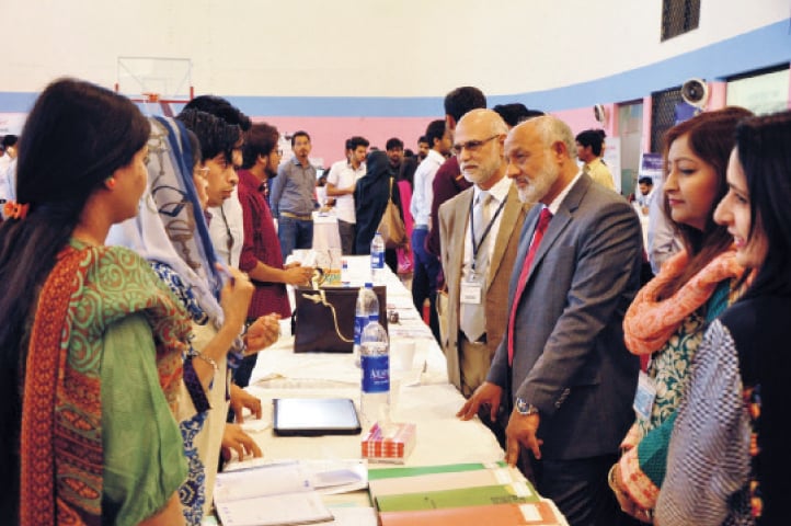 BAHRIA University Rector Vice Admiral retired Tanveer Faiz exchanges views with students at the job expo.