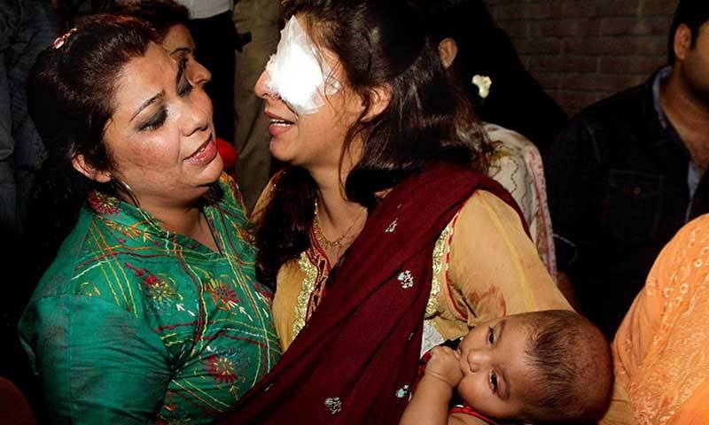 A woman injured in the bomb blast is comforted by a family member at a local hospital in Lahore, March, 27, 2016. — Photo by AP