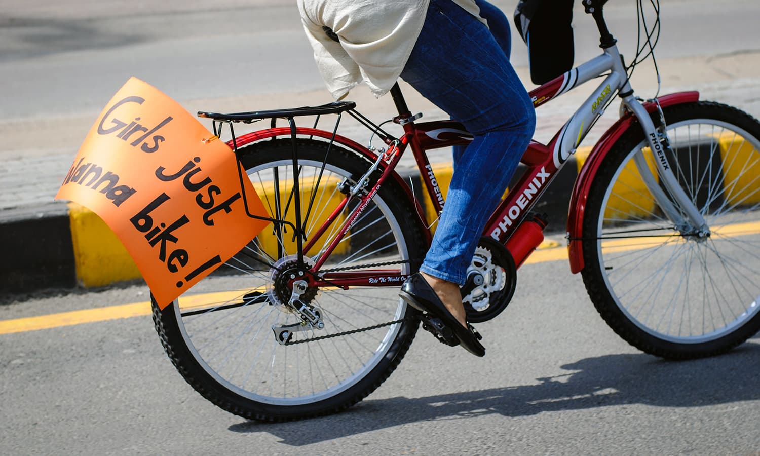 A girl carrying a poster at the bike rally. —Photo courtesy Girls at Dhabas/Hadi Khatri