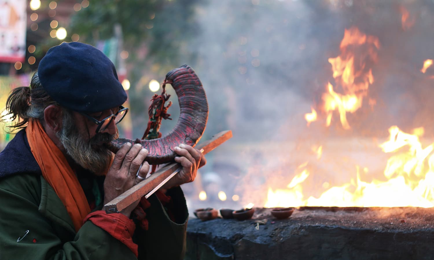 A man blows a herald at the shrine of Hazrat Madhu Lal Hassan.