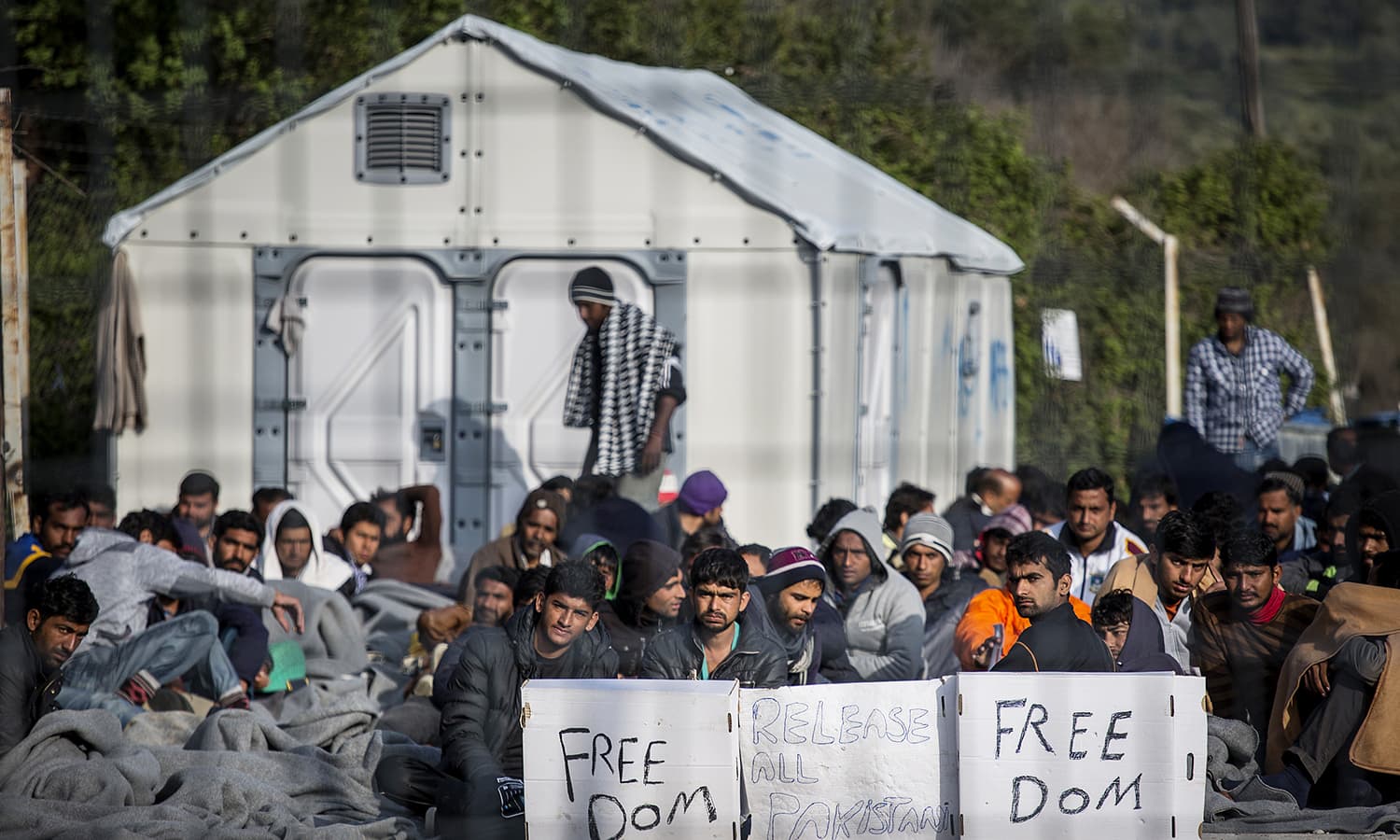 Pakistan migrants hold a hunger strike sit in protest at Moria Camp, a detention center on the Greek island of Lesbos on April 7, 2016. Hundreds of Pakistanis are trapped on the Greek island of Lesbos. Greece began deported immigrants to Turkey last week, among them more than 200 Pakistanis, vastly more than any other group.