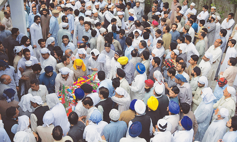 People attend the funeral of slain lawmaker Sardar Soran Singh in Pir Baba village of Buner district on Saturday.—AP