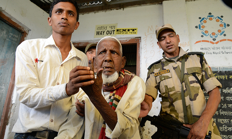 New Indian citizen of Masaladanga enclave is helped by his grandson Jamal Ali. &mdash;AFP