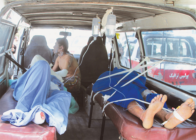 INJURED men lie in an ambulance after the accident on Sunday.&mdash;AP