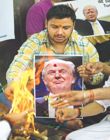NEW DELHI: Activists of right-wing Hindu Sena make offerings to the fire god while conducting rituals to pray for US presidential candidate Donald Trump&rsquo;s victory.&mdash;AP