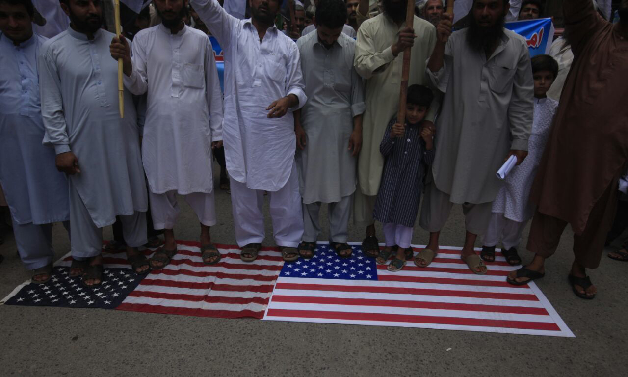 Attendees of the rally chanted slogans against US government and later desecrated the American flag. —DawnNews photo