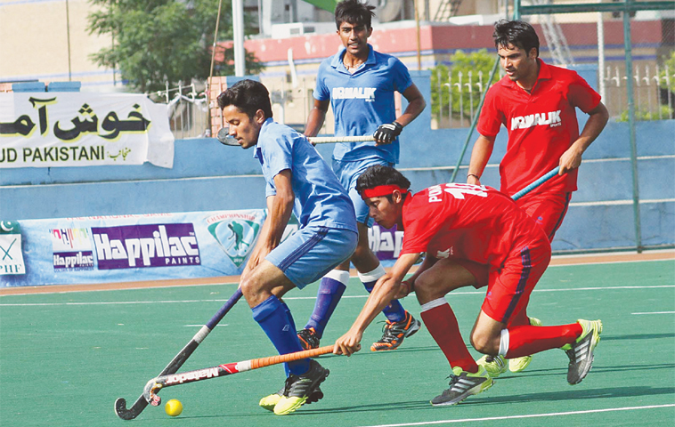 ISLAMABAD: Players of Punjab Blues and Punjab Colours vie for the ball during the semi-final of the National Under-18 Hockey Championship at the Naseer Bunda Hockey Stadium on Tuesday.&mdash;INP