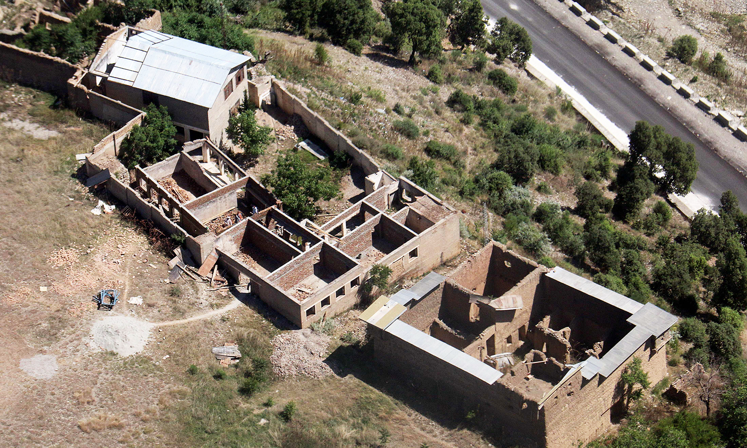 In this photograph taken from a Pakistani army helicopter on May 20, 2016, empty houses whose roofs have been removed by the army during an operation in South Waziristan.— AFP