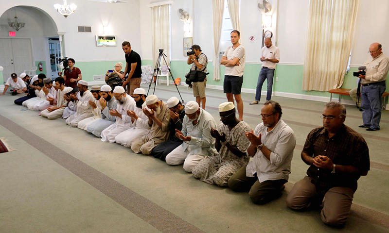 Worshippers listen as Imam Syed Shafeeq Rahman of the Islamic Center of Fort Pierce offers a prayer for victims of the Orlando shooting. &mdash;Reuters