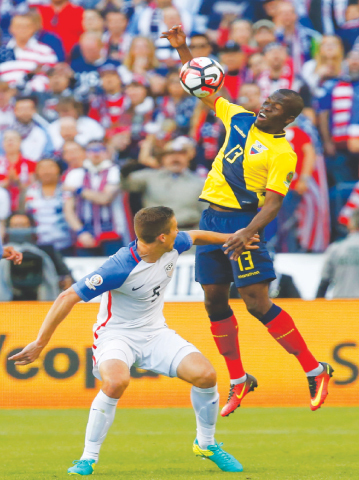 ECUADOR’s Michael Arroyo vies with Matt Besler of the US during their quarter-final.—Reuters