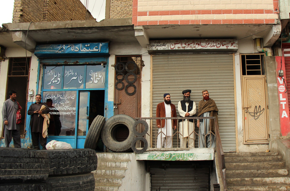 Haji Gul Kakar stands in front of the Balochistan Goods Truck Owners Association, Quetta