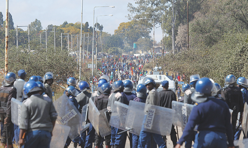 Zimbabwean police fire tear gas as taxi drivers’ protest turns violent
