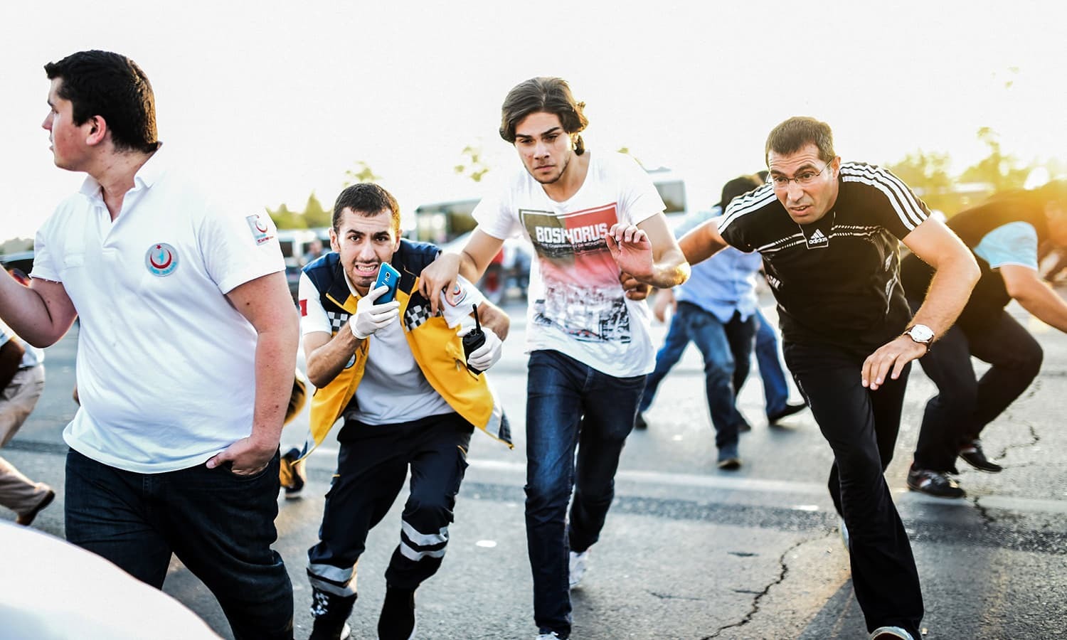 People run away on the Bosphorus bridge during clashes in Istanbul on July 16. — AFP