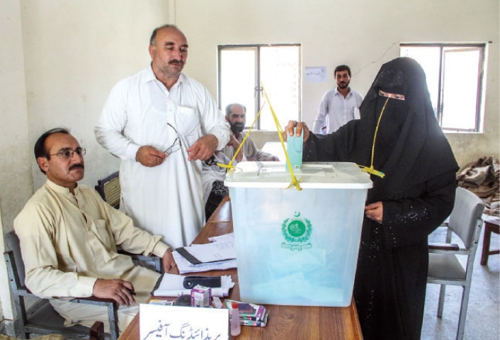 A woman casts her vote in Swat on Thursday. &mdash; Dawn