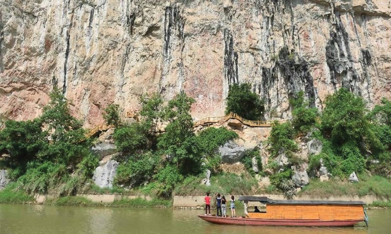TOURISTS view Huashan rock paintings on the cliffs along the Mingjiang river in southwest China&rsquo;s Guangxi Zhuang Autonomous Region. The rock paintings, which consist of more than 1,900 drawings depicting drums and related elements, are symbolic records directly associated with the bronze drum culture of the Luoyue people once widespread in the region over 2,000 years ago. The site was added to the Unesco&rsquo;s World Heritage List on July 22.