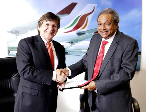 COLOMBO: PIA’s Chief Executive Officer Bernd Hildenbrand (left) shakes hands with Chairman of Sri Lankan Airlines Ajith Dias after signing a contract for the wet lease of three A-330 aircraft on Friday.—INP