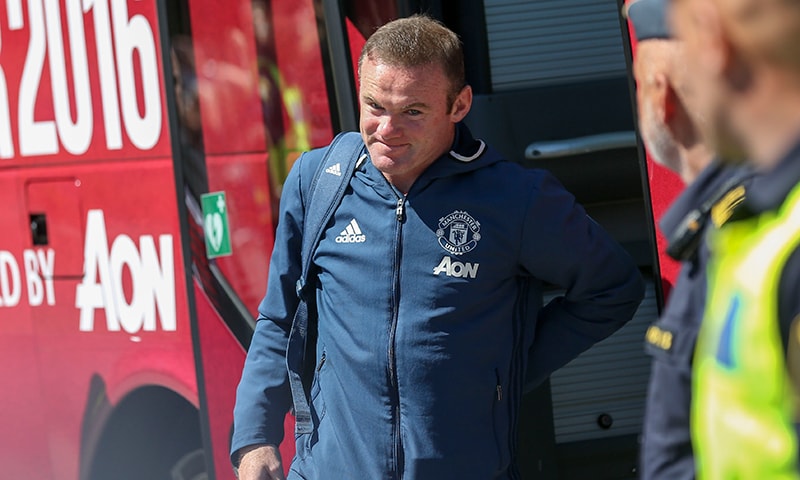 Manchester United's striker Wayne Rooney exits the team bus at the hotel in Gothenborg on July 30. &mdash; AFP