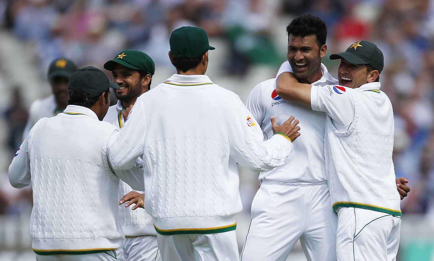 Sohail Khan celebrates with team mates after taking the wicket of England's Joe Root. — Reuters