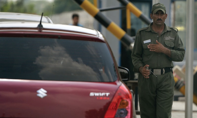 ISLAMABAD: This file photo taken on Aug 1 shows a private security guard using an explosives detector to search a vehicle at a mall entrance.&mdash;AFP