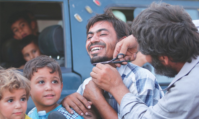 Manbij: A man has his beard trimmed after fighters of the Syria Democratic Forces took control of this northern Syrian city from the militant Islamic State group. The IS had imposed a harsh and extreme version of Islam on the territory under its control.&mdash;Reuters