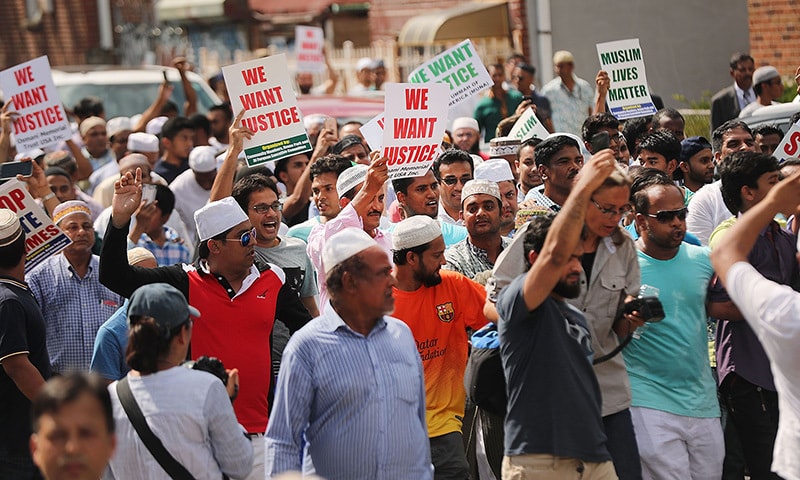 People march after a mass prayer for Imam Akonjee and his assistant in New York on Aug 15.— AFP