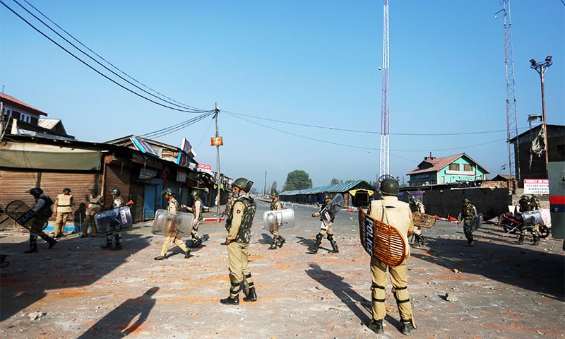 Indian policemen patrol on a street during a curfew in Srinagar, August 16.—Reuters