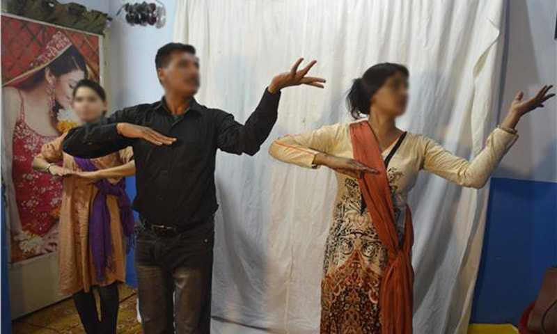 Rashid Bhatti, a dance instructor, teaching students dance steps at his dance academy in Lahore ─ AFP