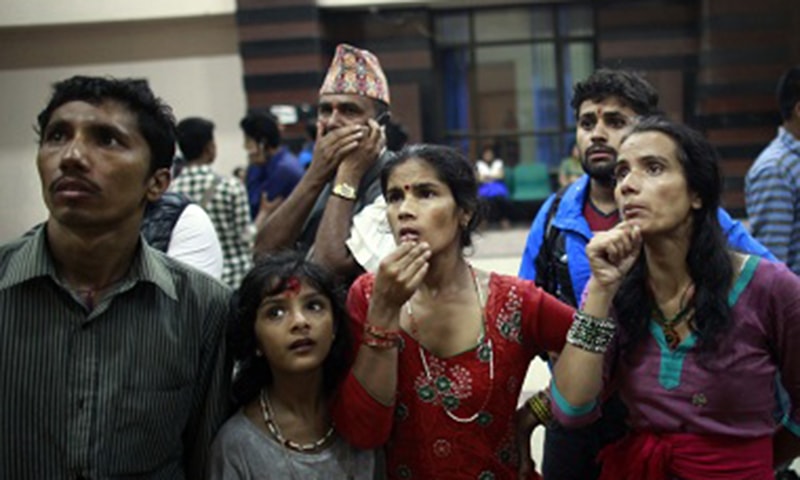 Family members of passengers involved in the bus accident, look at a list of survivors airlifted for treatment ─ AP