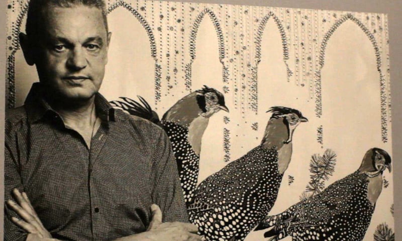 Artist Maurizio Boscheri poses next to one of his paintings. Photo: Aamir Baig/Dawn.com