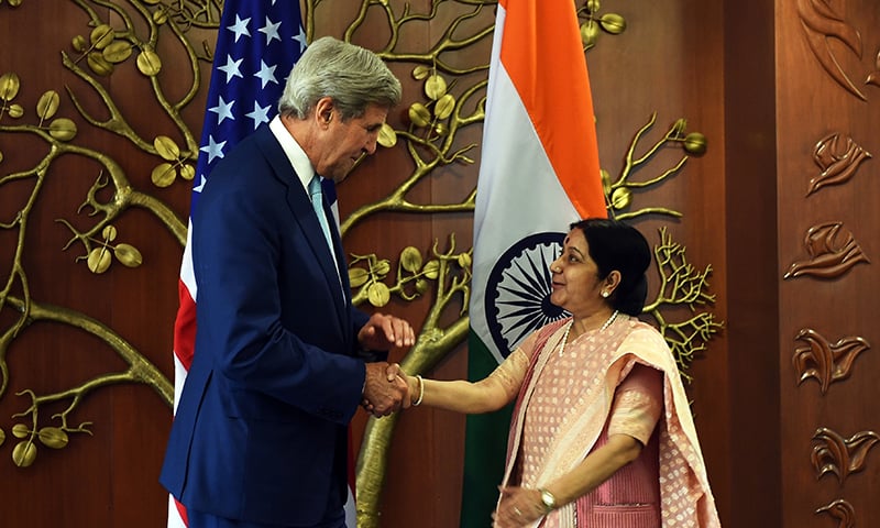 Indian Minister of External Affairs Sushma Swaraj and US Secretary of State John Kerry shake hands prior to a meeting in New Delhi. -AFP