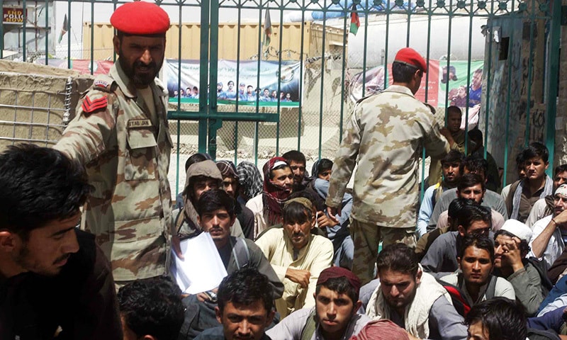 Afghan nationals arrested under the Foreigners Act are being  handed over to Afghan National Army personnel at Chaman border on Friday.— PPI