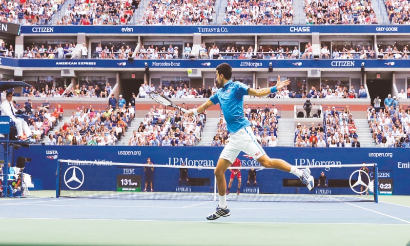NOVAK Djokovic hits a return to Stan Wawrinka.—AP NOVAK Djokovic hits a return to Stan Wawrinka.—AP