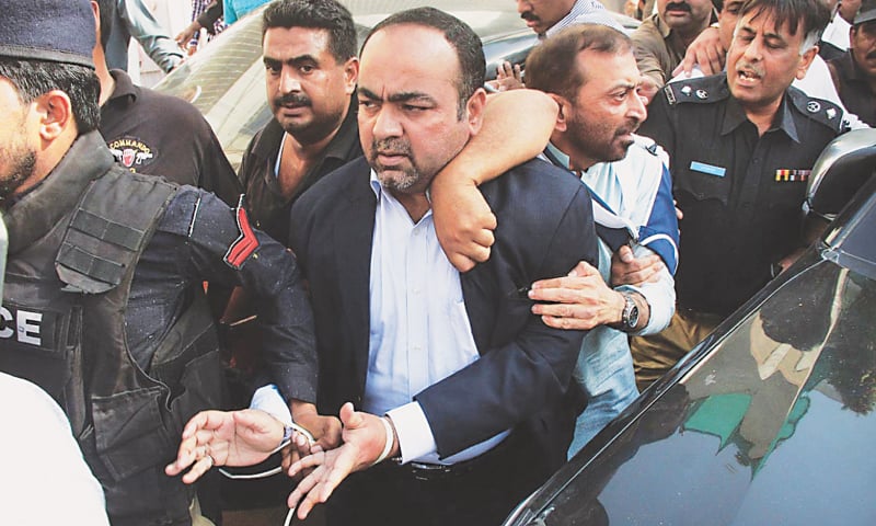 KARACHI: Policemen escort Leader of the Opposition in the Sindh Assembly Khawaja Izhar-ul-Hasan following his arrest in a raid on his home on Friday.&mdash;Online